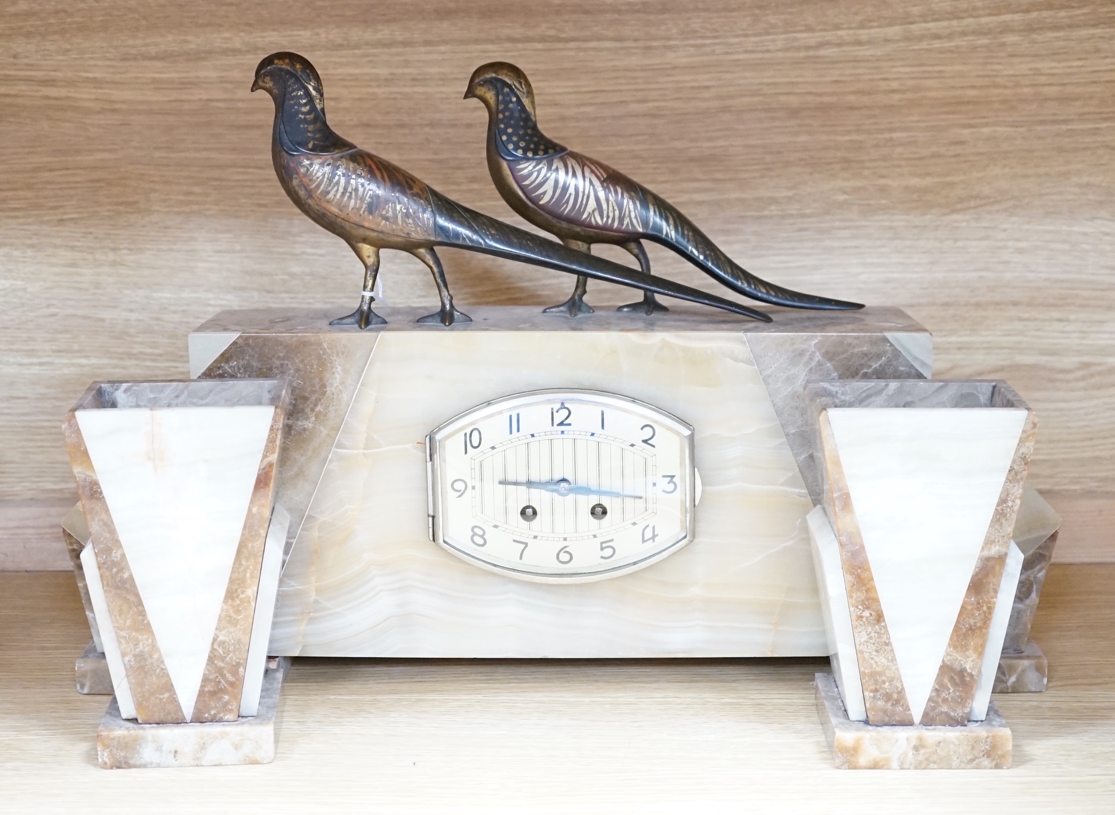 An Art Deco clock garniture, bronze mounted, signed segundo, with gilt bronze birds on top, height 34cm, length 55cm